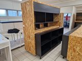a room with a counter, cabinets, and other items in it