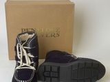 the shoes are purple and black with white laces on them