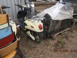 a scooter that is parked in front of a building