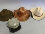 several different hats are lined up on a white surface