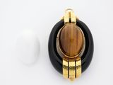 an image of a black and gold pendant with a tiger ' s eye stone