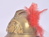 a gold helmet with a red feather on top of it