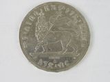 an old british one pound coin on a white surface