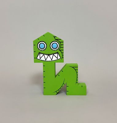green wooden letter n with a monster face on it