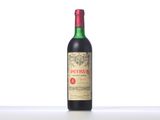 a bottle of red wine sitting on top of a table