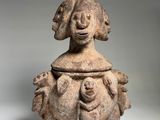 a close up of a vase with a face on it