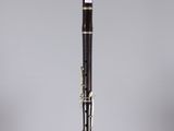 a close up of a clarinet on a stand with a white background