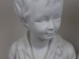 a white bust of a boy and a white bust of a girl