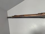 an old gun mounted on a wall in a room