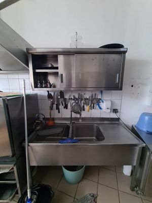 a kitchen with a sink and a refrigerator in it
