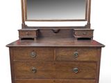 an antique dresser with a mirror on top of it