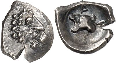 a close up of a silver coin with a face on it