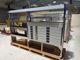 a metal cabinet with drawers on a pallet in a warehouse