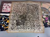 many different types of scarves laid out on a table