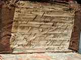 an old book with writing on it sitting on a table