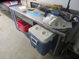 an image of a kitchen area with a table and a cooler
