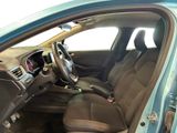 the interior of a blue car with a steering wheel and dashboard