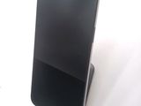 a cell phone that is sitting on top of a stand