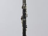 a black and gold clarinet sitting on top of a clear stand