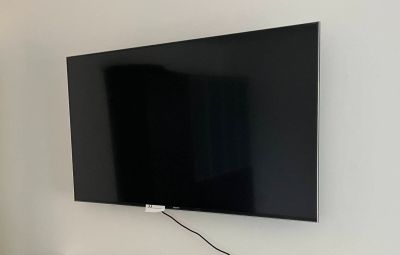 a flat screen tv mounted on the wall in the living room