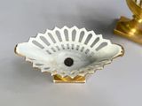 a small white bowl with a brown button in it