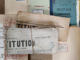 a pile of old papers sitting on top of a wooden table