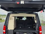 the back of a van with a bed in the back of it
