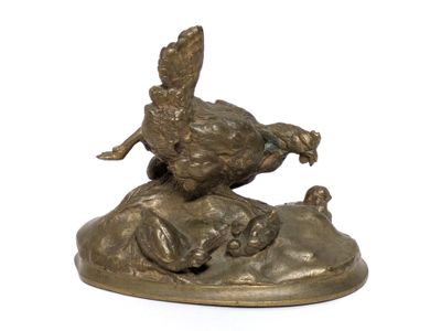 a bronze statue of a pheasant on top of a rock