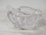 a glass bowl with two spoons in it on a table