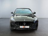 the front of a black maserator parked in a white room