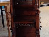 a tall wooden shelf with a clock on it