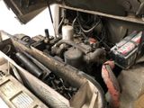 an image of a car engine with its hood open and a car battery in it