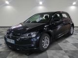 the black volkswagen golf is parked on a checkered tile floor