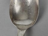 a silver spoon with a handle on a table