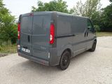 a grey van that is parked in a parking lot