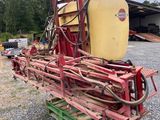 a red tractor with a yellow tank sitting on top of it