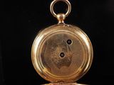 a gold pocket watch with a picture of a man on it