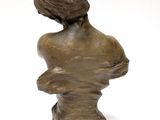 an image of a bronze busturine of a woman on a stand