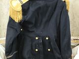 a suit case that has a jacket and hat inside of it