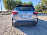 the rear end of a silver citrole parked in a parking lot
