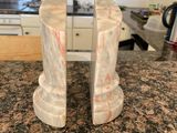 pair of marble bookends on granite countertop in kitchen