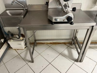a kitchen with a sink and a counter with a blender on it