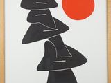 a framed picture of a black and white poster with a red sun in the background