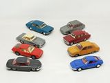 several toy cars are lined up in a row on a white surface