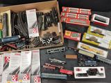 a box full of toy train tracks and other toy trains