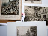 several pictures of old books on a table with papers on them