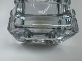 a glass ashtray that is sitting on a table