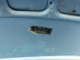 a close up of a blue car with a sign on it