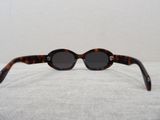 a close up of a pair of sunglasses on a white surface