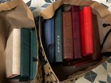 a brown paper bag filled with books on a tiled floor